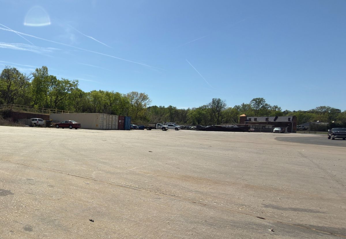 Open laydown yard looking toward the office building
